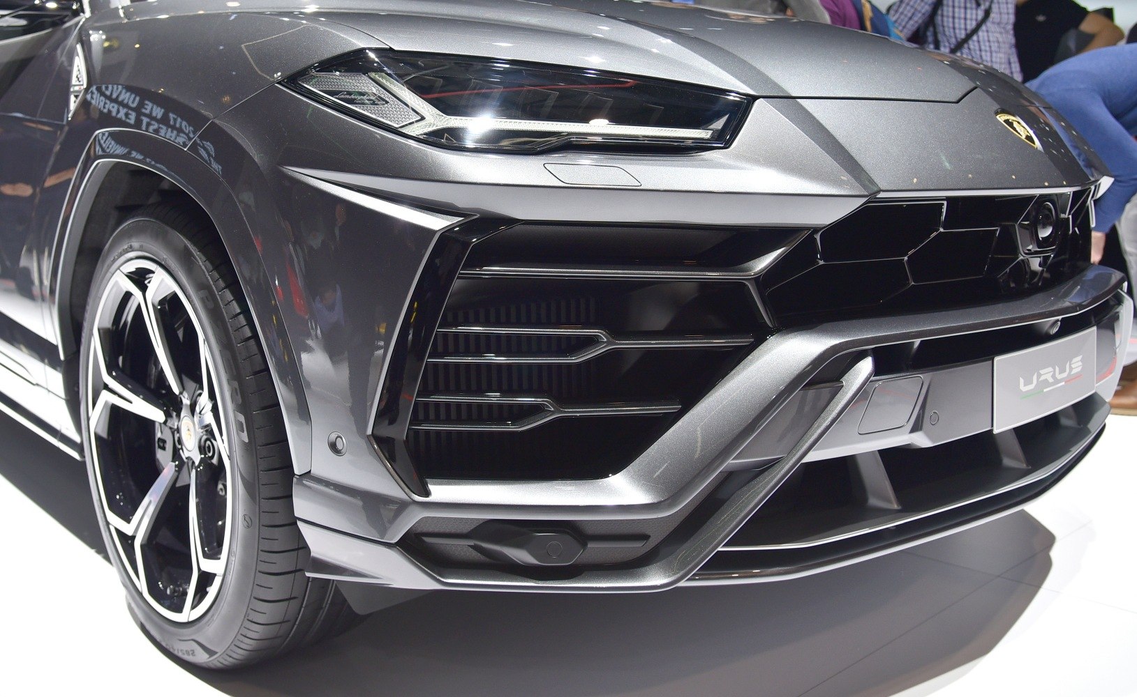 Close-up view of front grille, headlight, and wheel rim