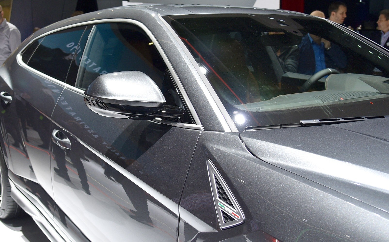 Close-up of side mirror and fender vent with metallic gray paint