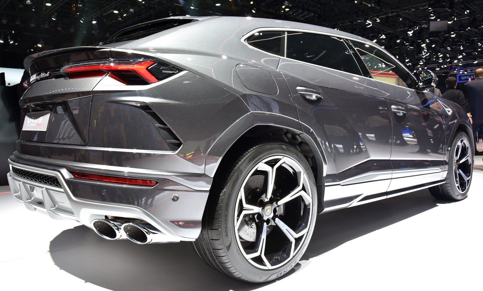 Rear profile with tail lights, exhaust pipes, and distinctive alloy wheels.