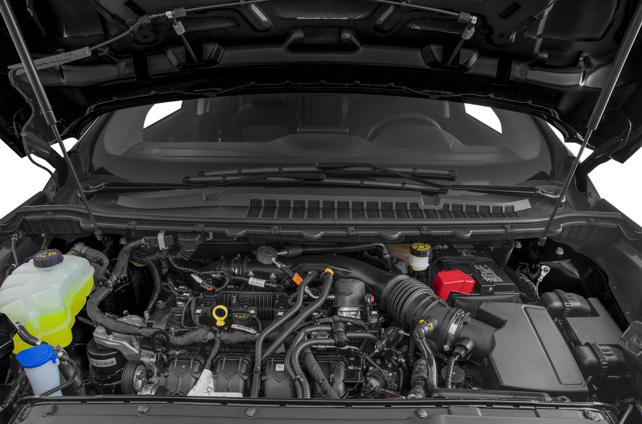 Modern engine bay with fluid reservoirs and complex wiring