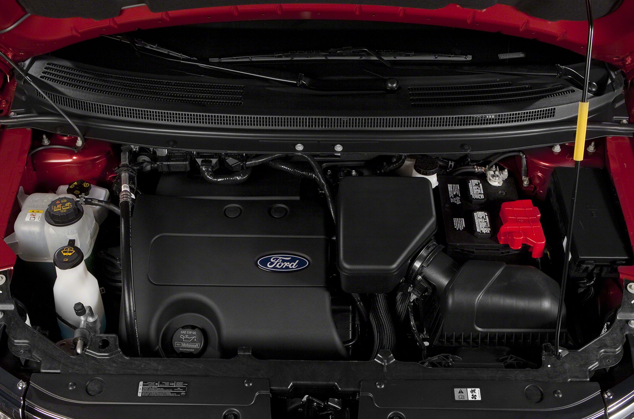 Close-up of engine bay with covered engine and battery compartment