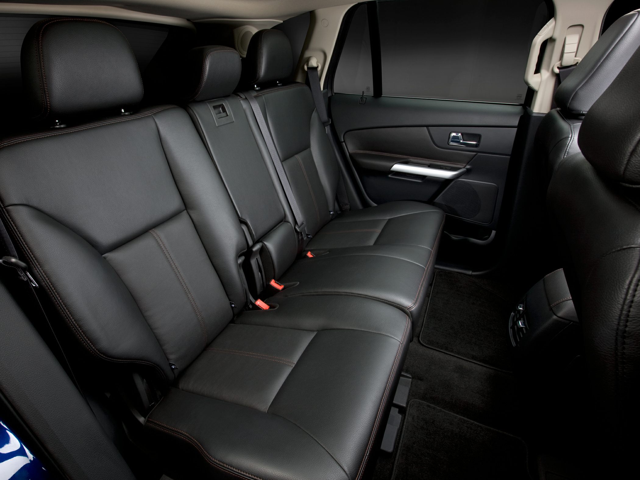 Black leather rear seats with headrests and seatbelt in SUV interior