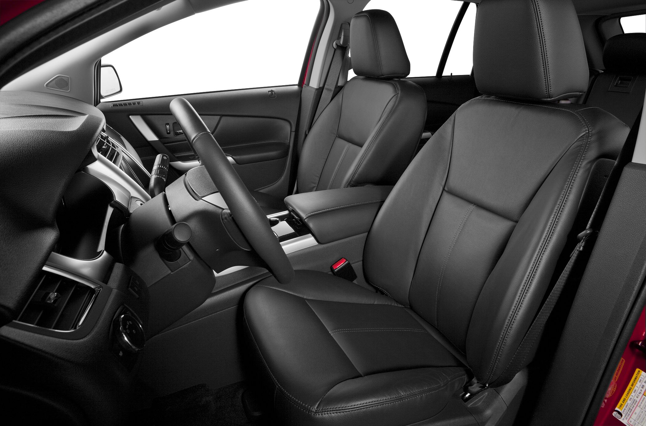 Leather front seats and steering wheel in a modern car interior.
