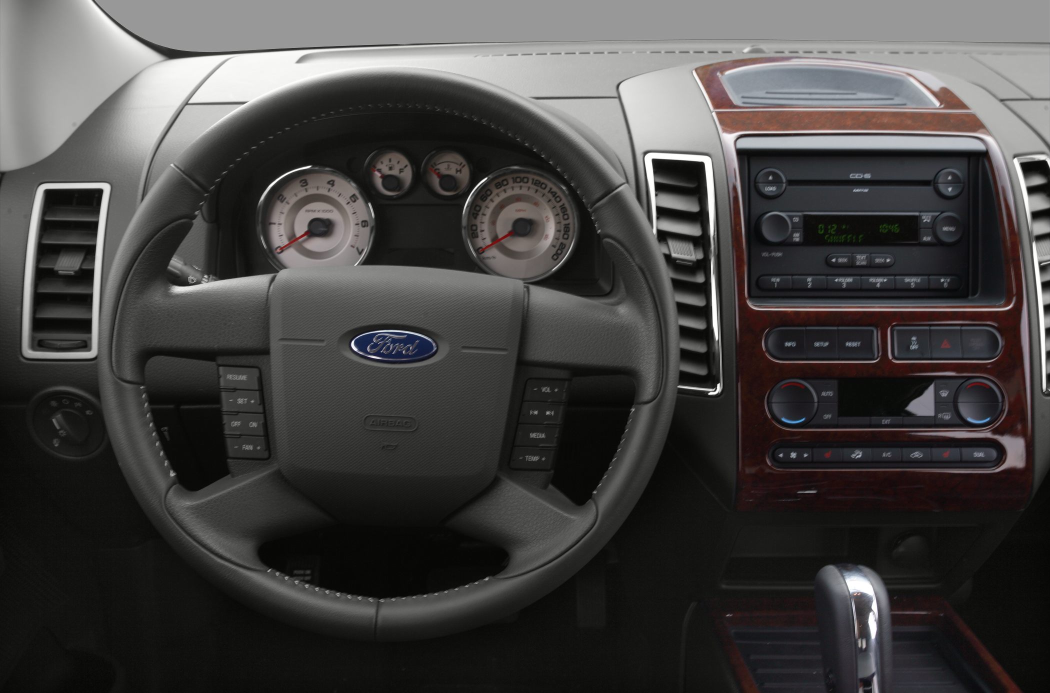 Steering wheel and dashboard with gauges, radio, and climate controls