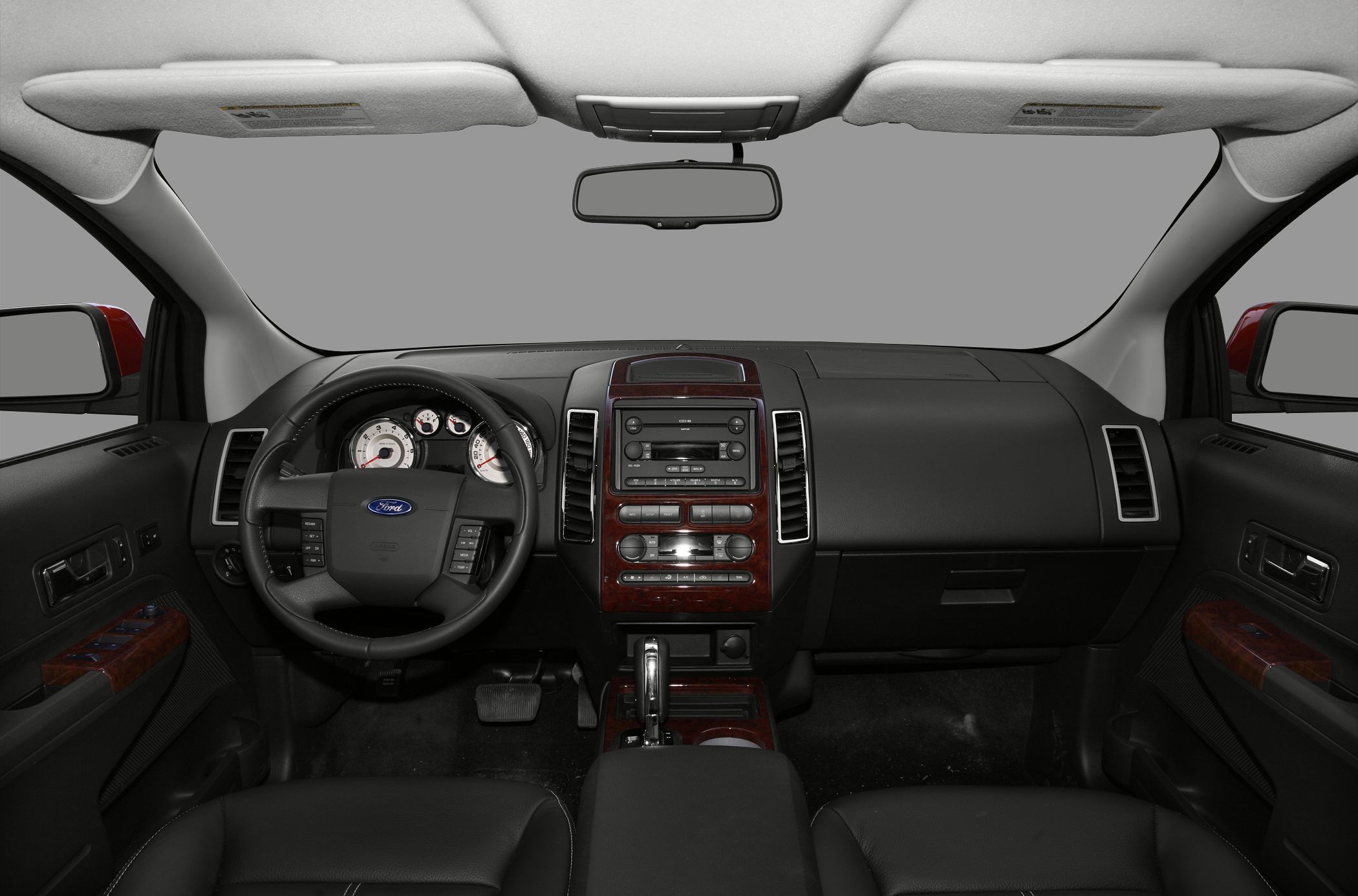 Interior dashboard and steering wheel with wood trim and controls