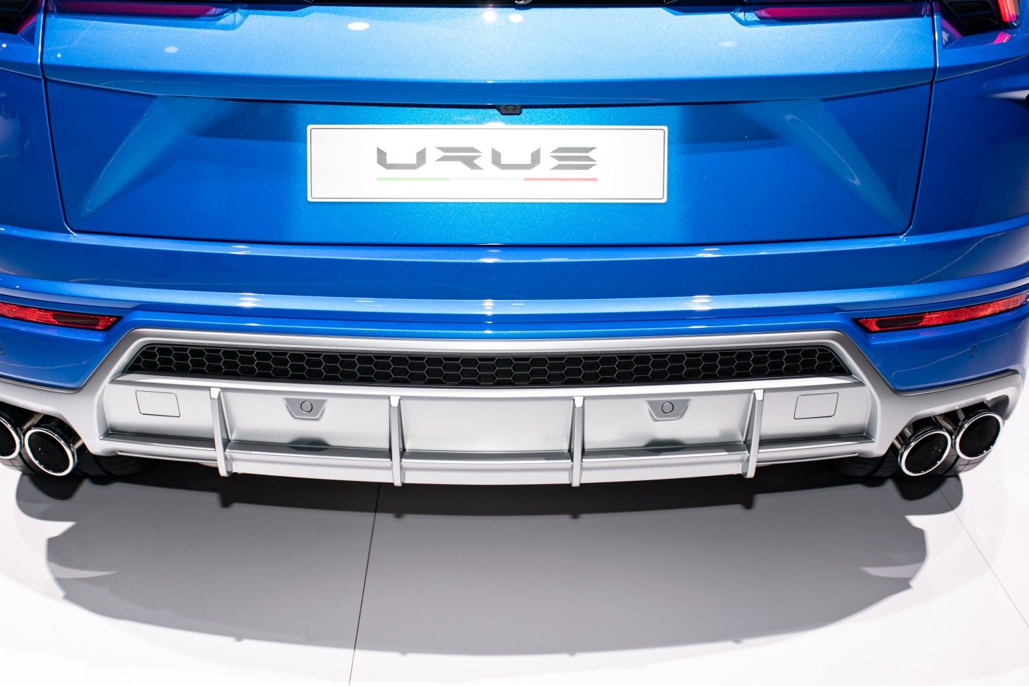 Close-up of rear quad exhaust pipes and aerodynamic diffuser
