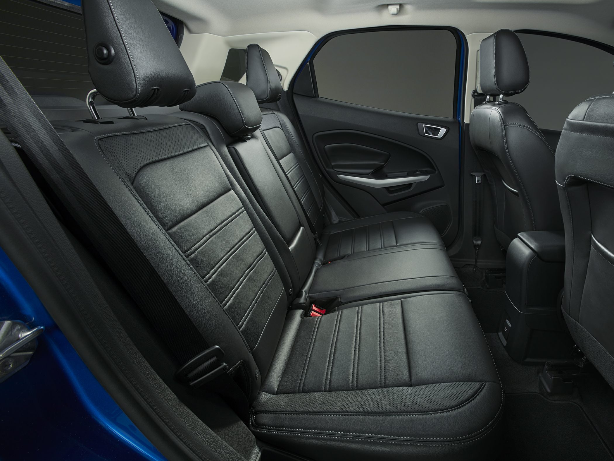 Black leather rear seats with detailed stitching and car door panel
