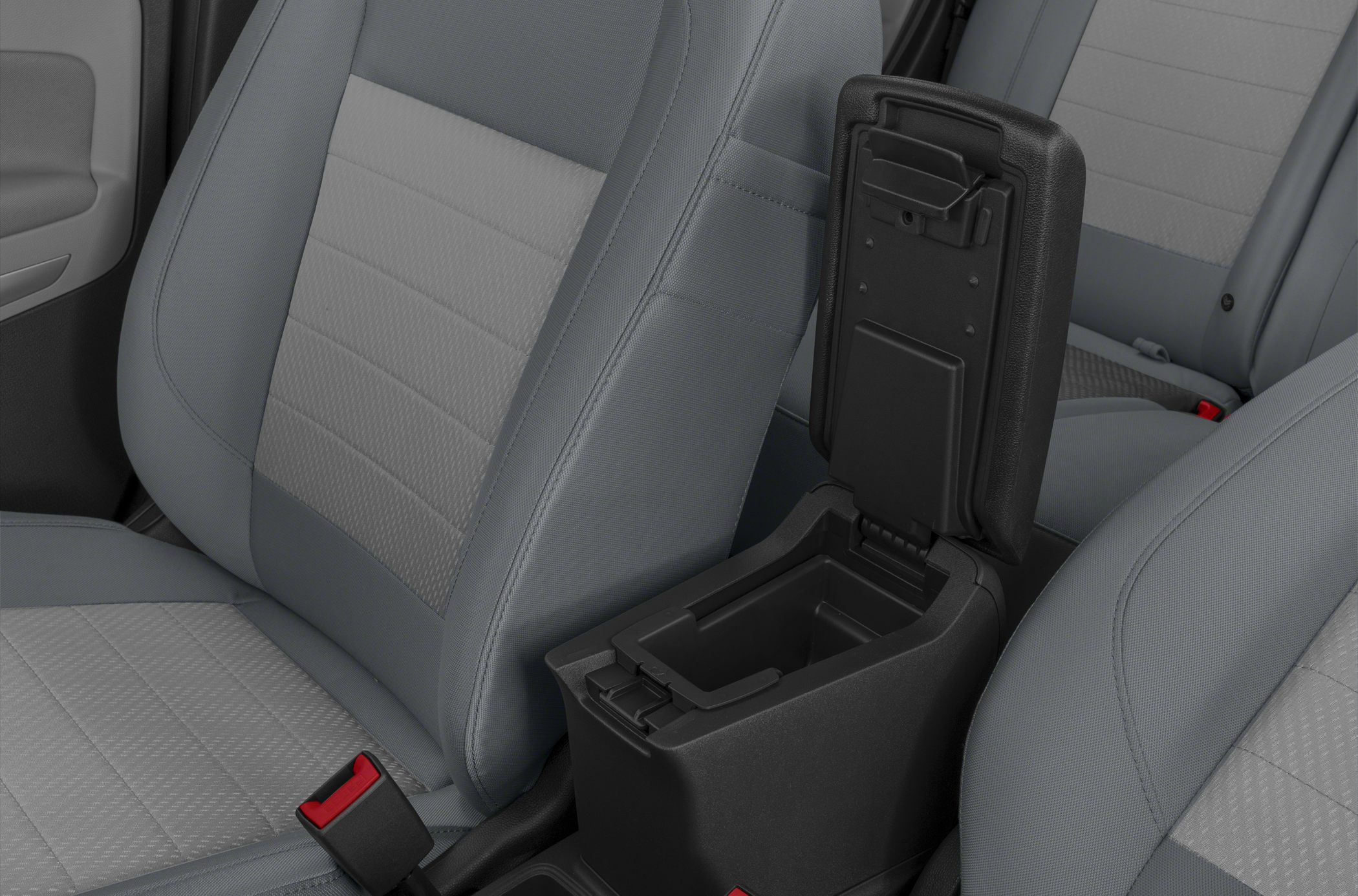 Open center console armrest storage between front seats in gray fabric interior