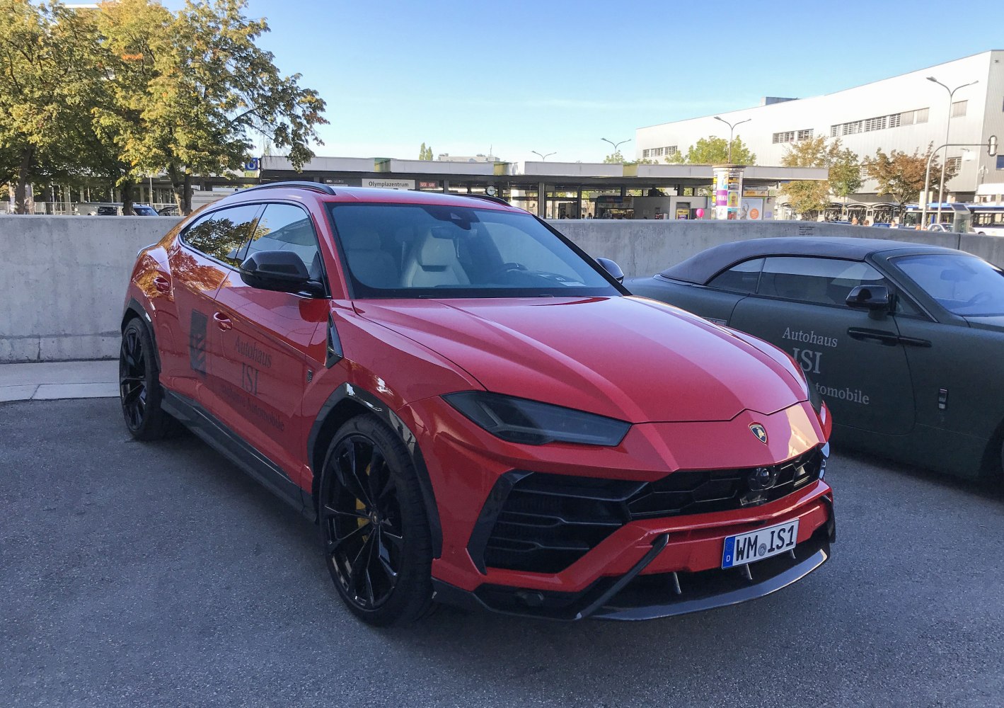 Red SUV with aggressive front grille and black alloy wheels