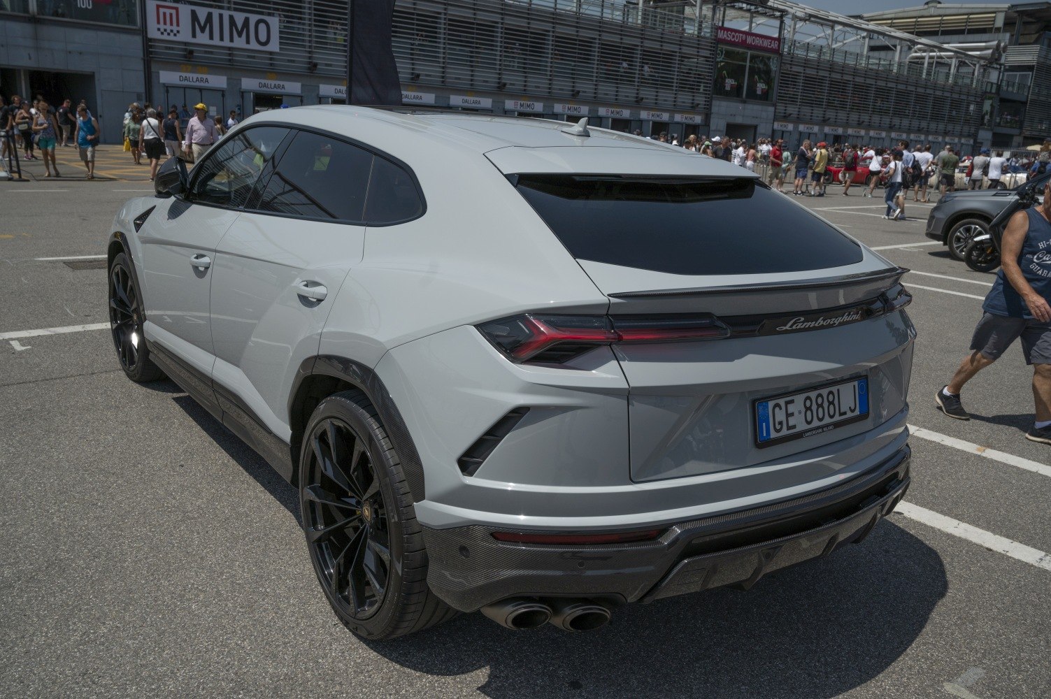 Rear view of luxury SUV with black wheels and quad exhaust pipes