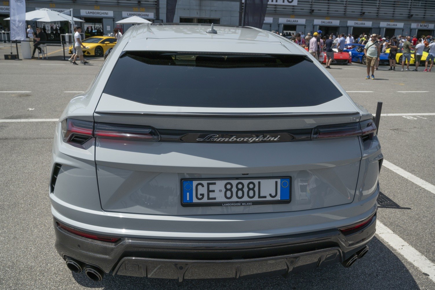 Rear view with tail lights, rear diffuser, and dual exhaust pipes.