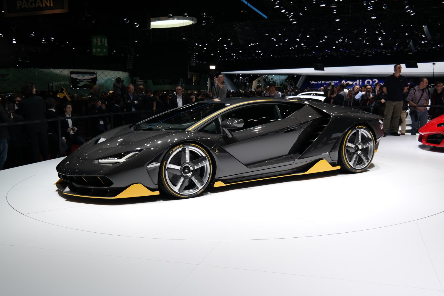 Carbon fiber supercar with yellow accents and racing tires.
