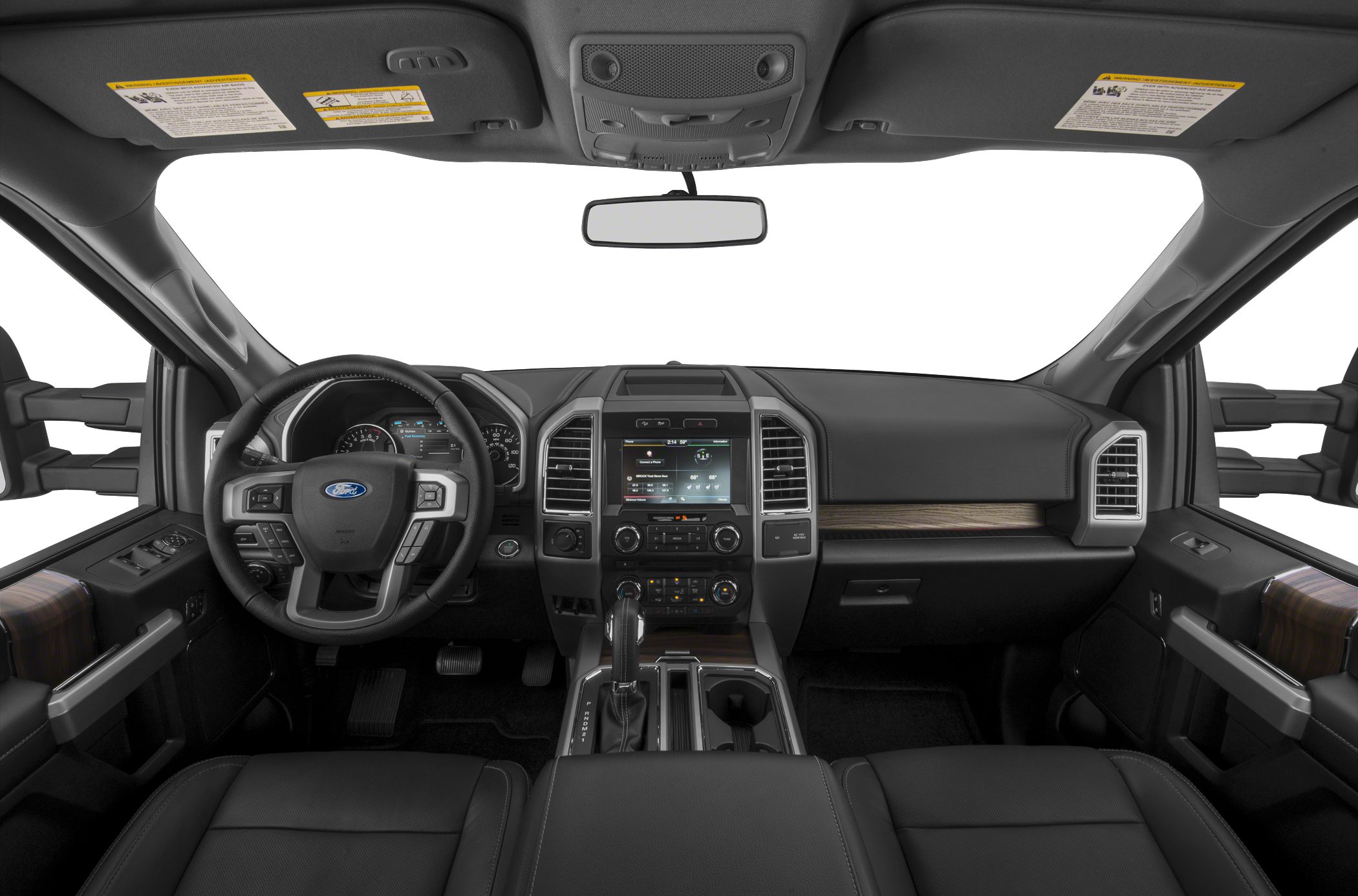 Steering wheel, dashboard with digital display, center console, and wood trim inside truck cabin