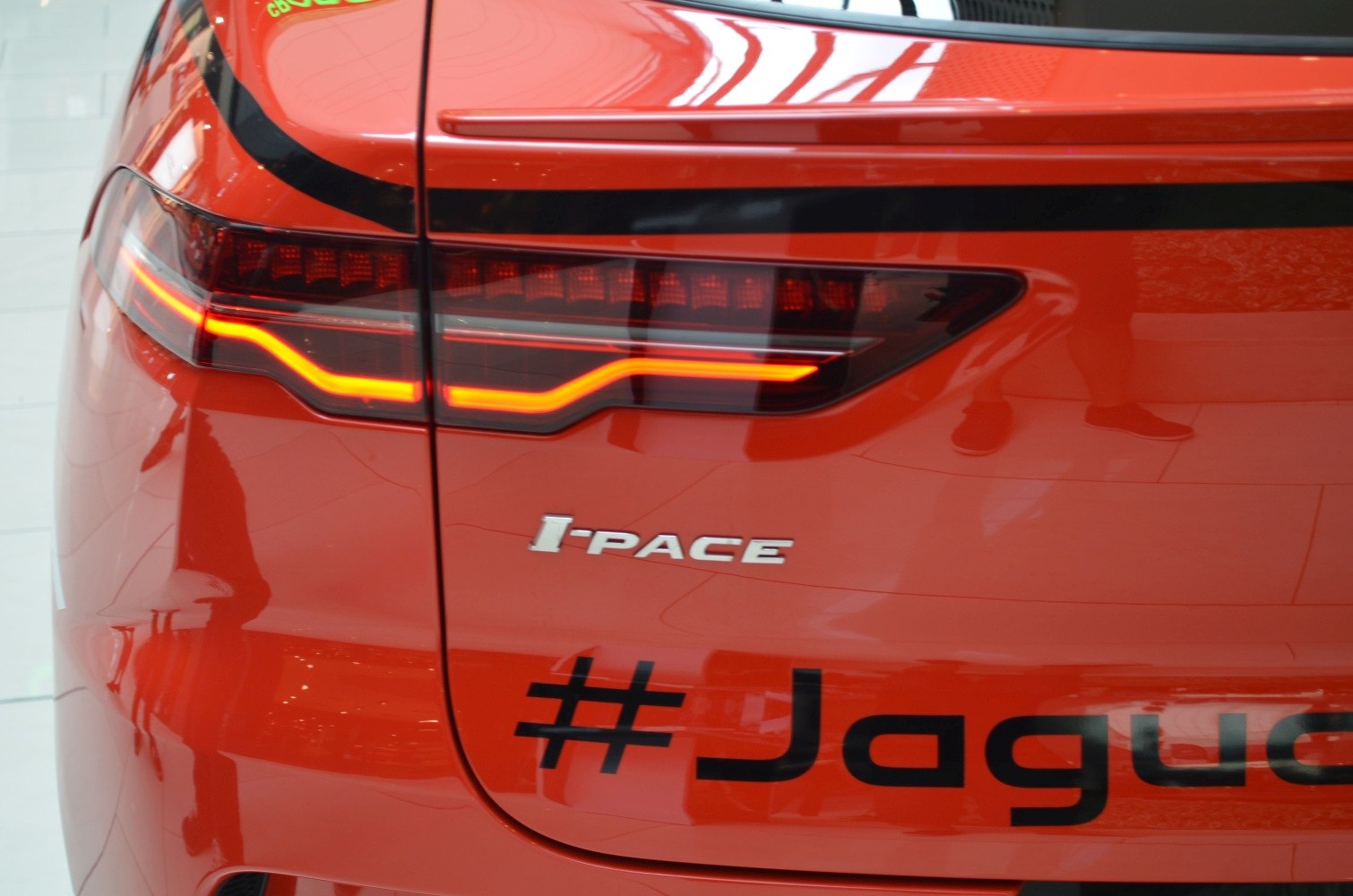 LED tail light and badge detail on bright orange rear