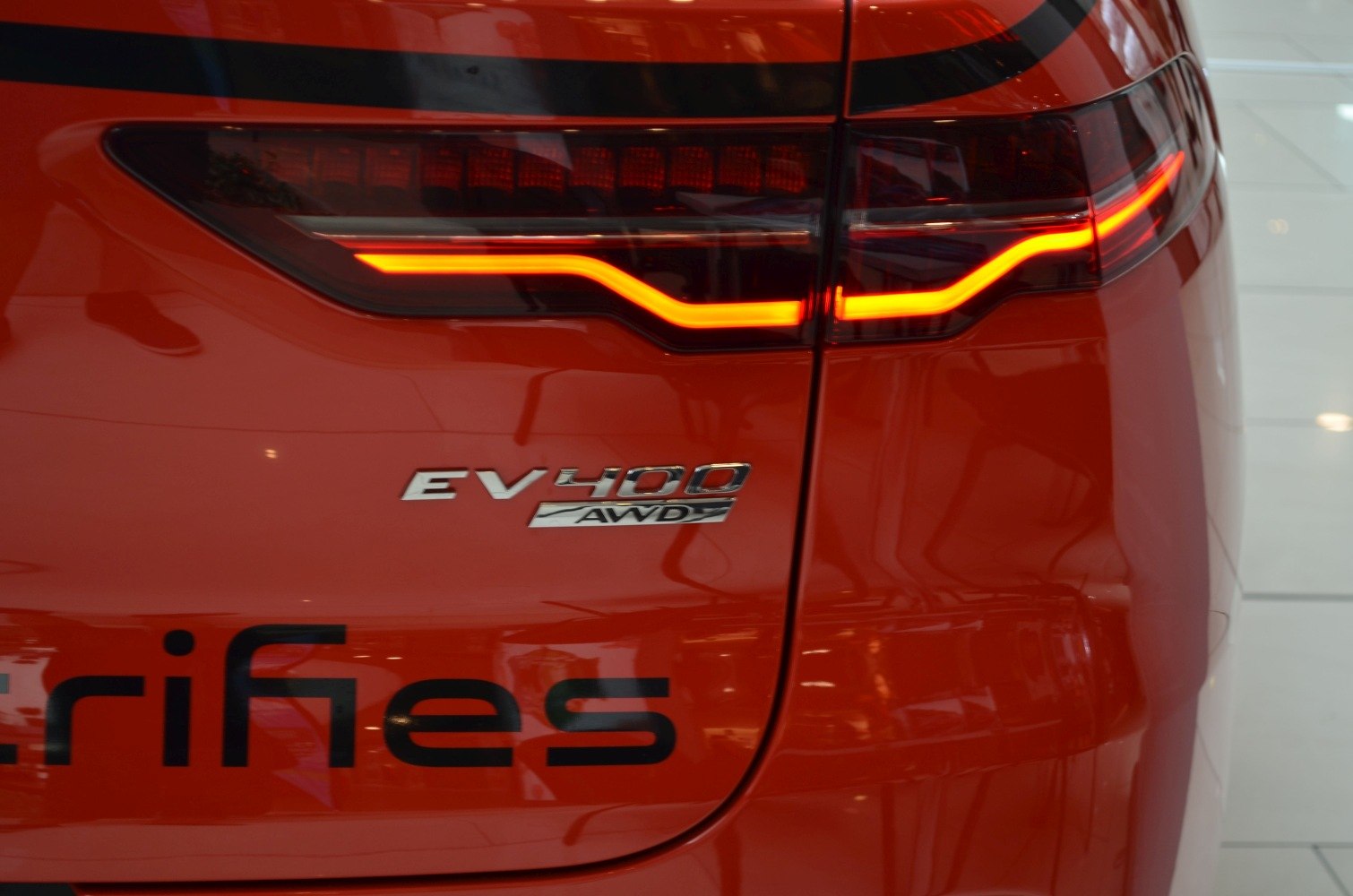 Rear LED taillight and EV400 AWD badge on a red vehicle