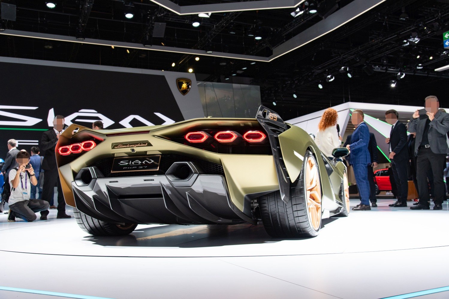 Rear view with hexagonal tail lights and one open upward door