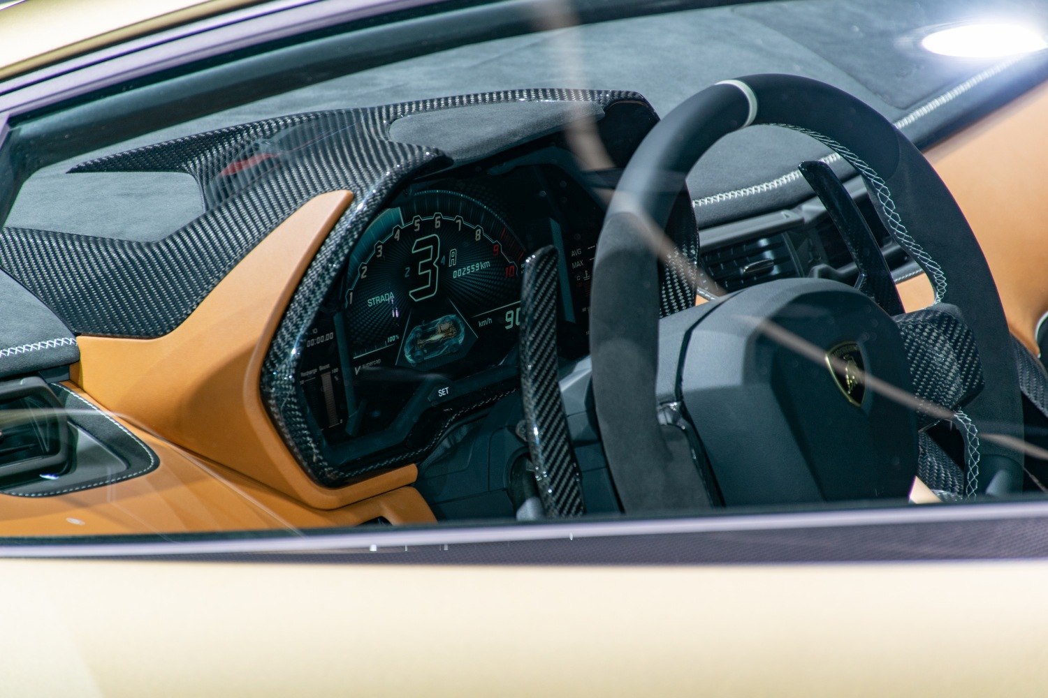 Digital dashboard and carbon fiber interior trim with Alcantara steering wheel stitching