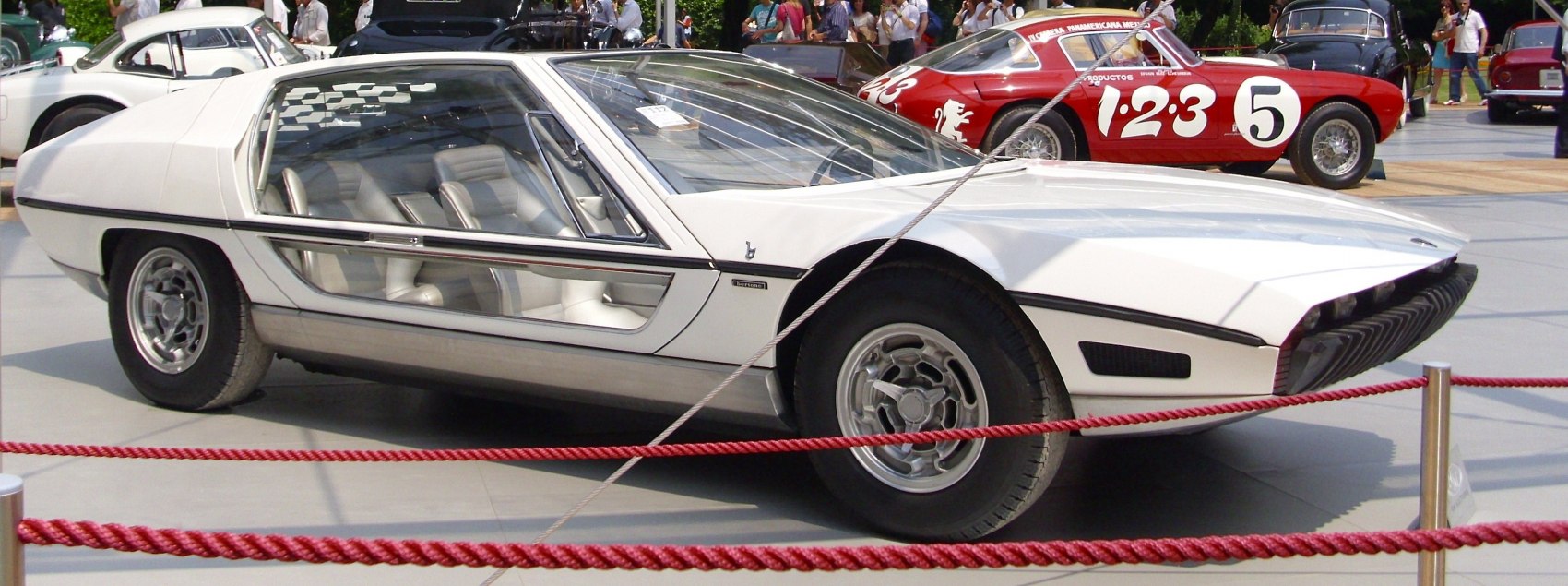 Glass canopy sports coupe with wedge-shaped body and unique door design