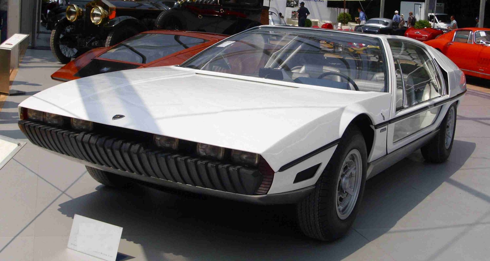 Concept car with transparent gullwing doors and sharp angular front.