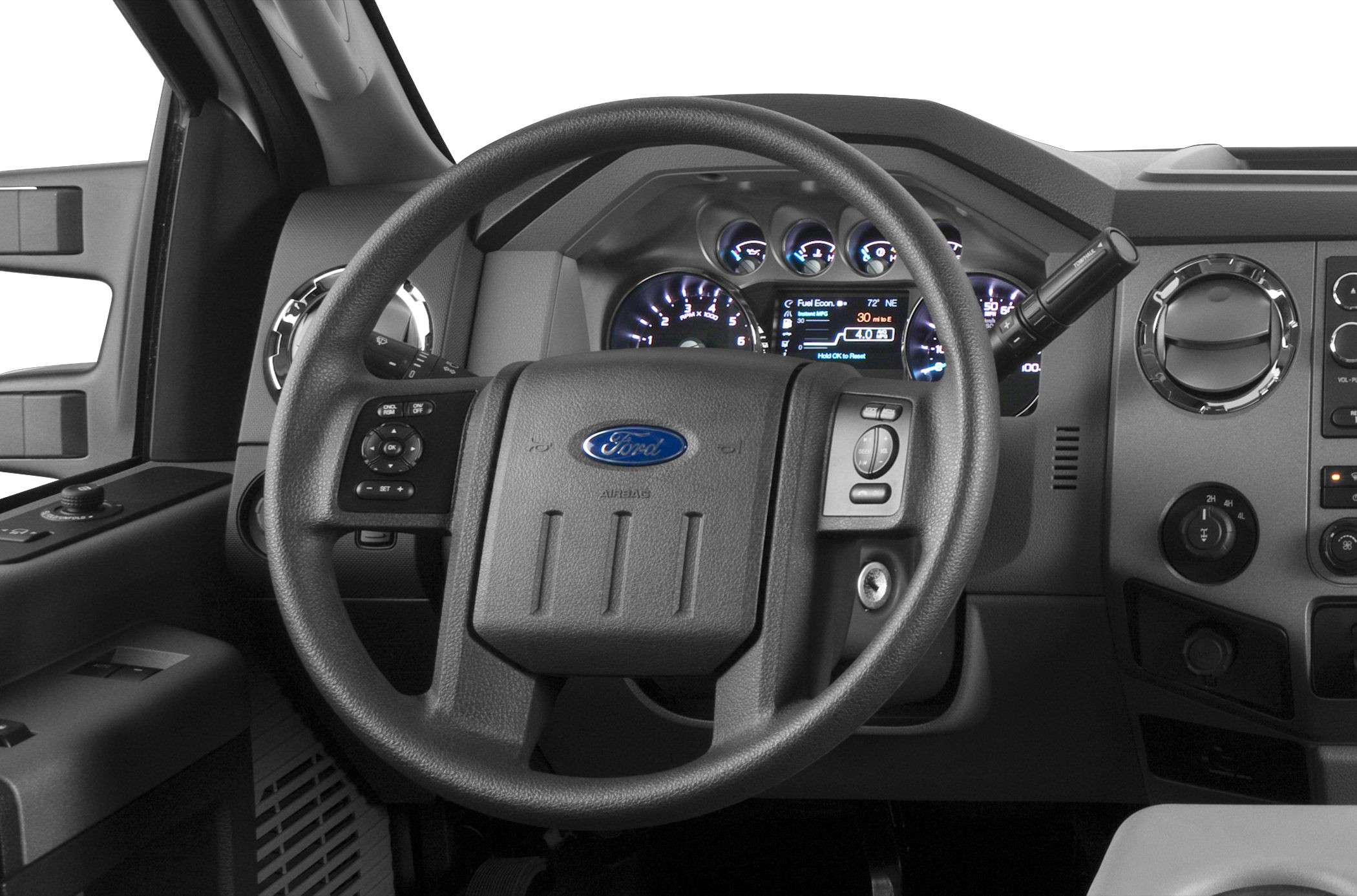 Steering wheel, dashboard, instrument cluster, and control elements inside a truck cabin