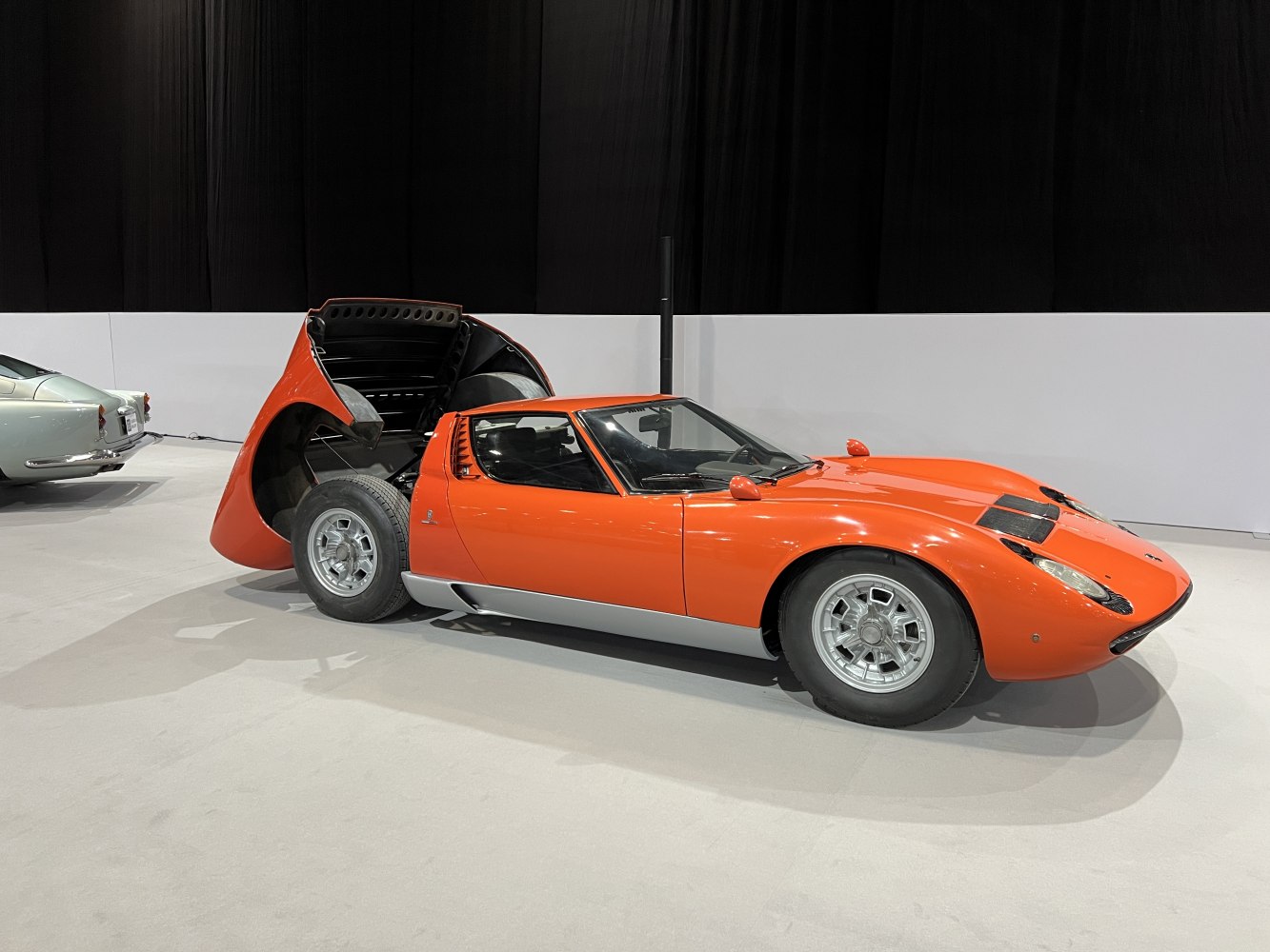 Vintage sports car with open rear hood revealing mid-engine design