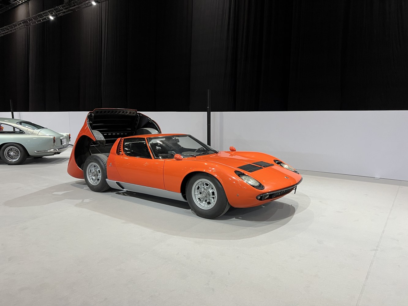 Mid-engine classic car with open rear engine cover and sleek shape