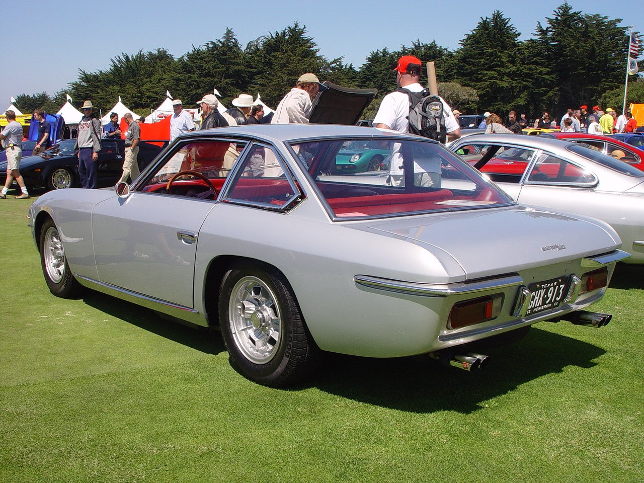 Rear angled view of a vintage 1960s sports coupe with dual exhaust