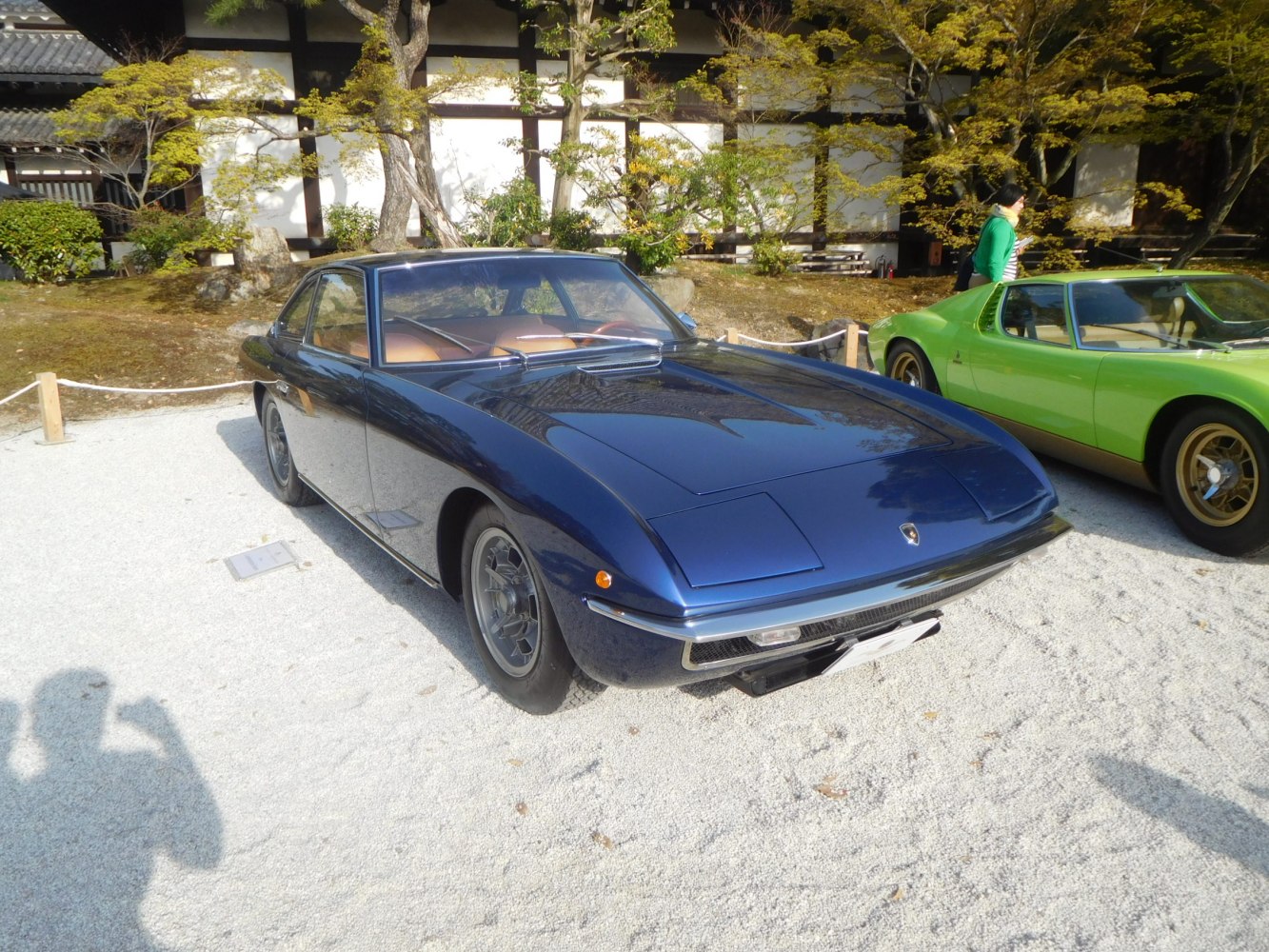 Front 3/4 view of a classic vintage coupe with sleek lines and pop-up headlights.