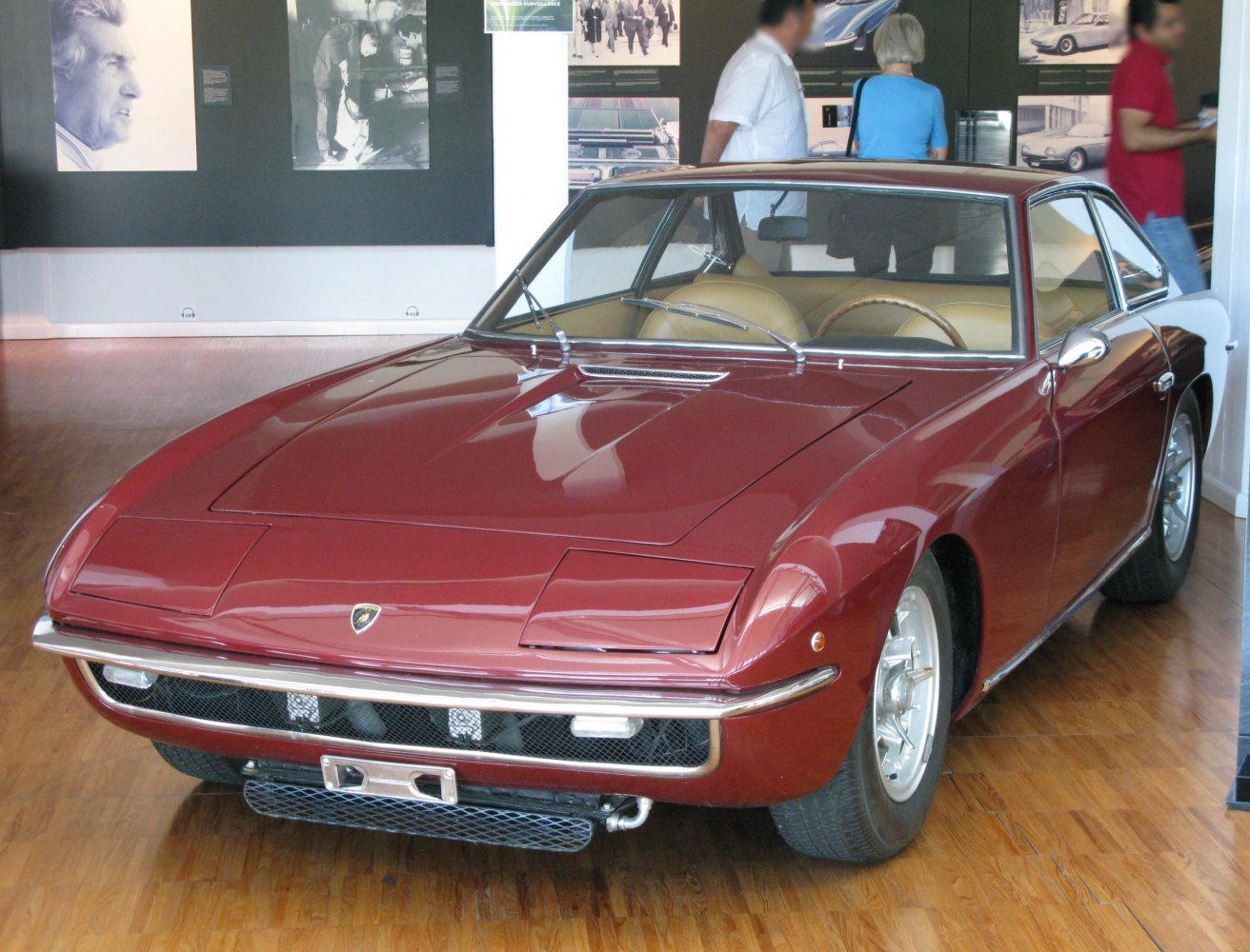 Front view of a vintage sports coupe with retractable headlights and sleek body lines