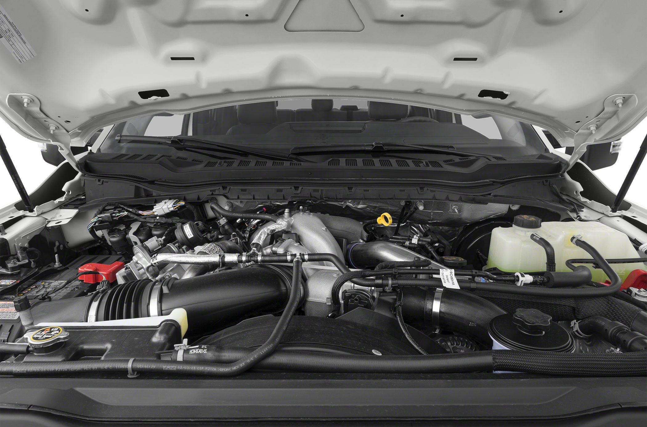 Detailed engine bay with assorted automotive components and hoses