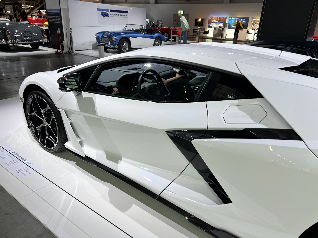 White sports car side profile with aerodynamic styling and sharp lines.