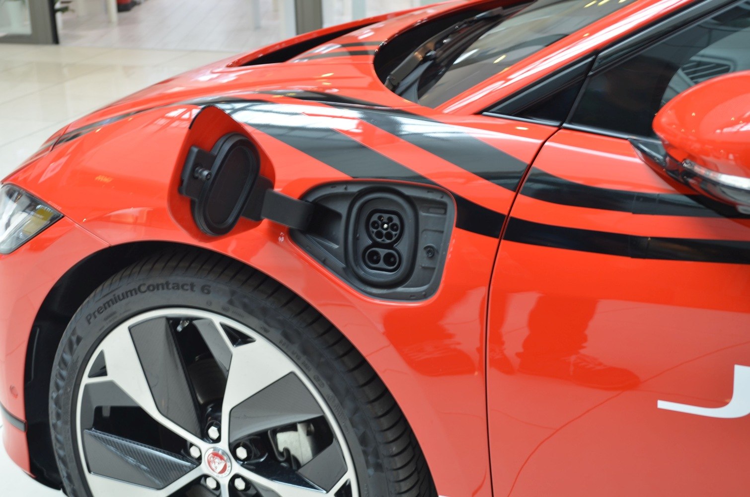 Electric vehicle charging port and alloy wheel close-up