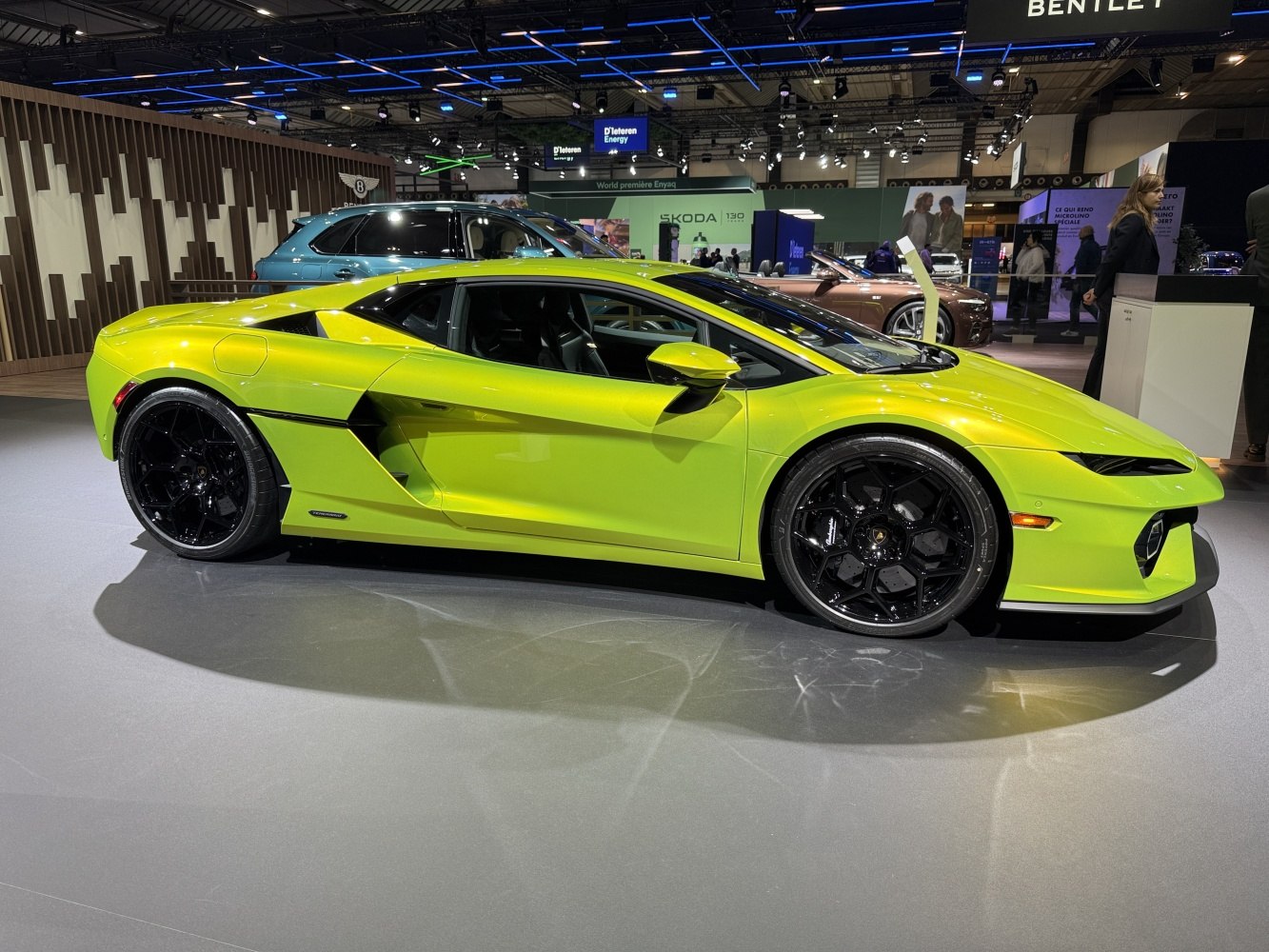 Sleek lime green sports car with sharp aerodynamic lines and large black alloy wheels