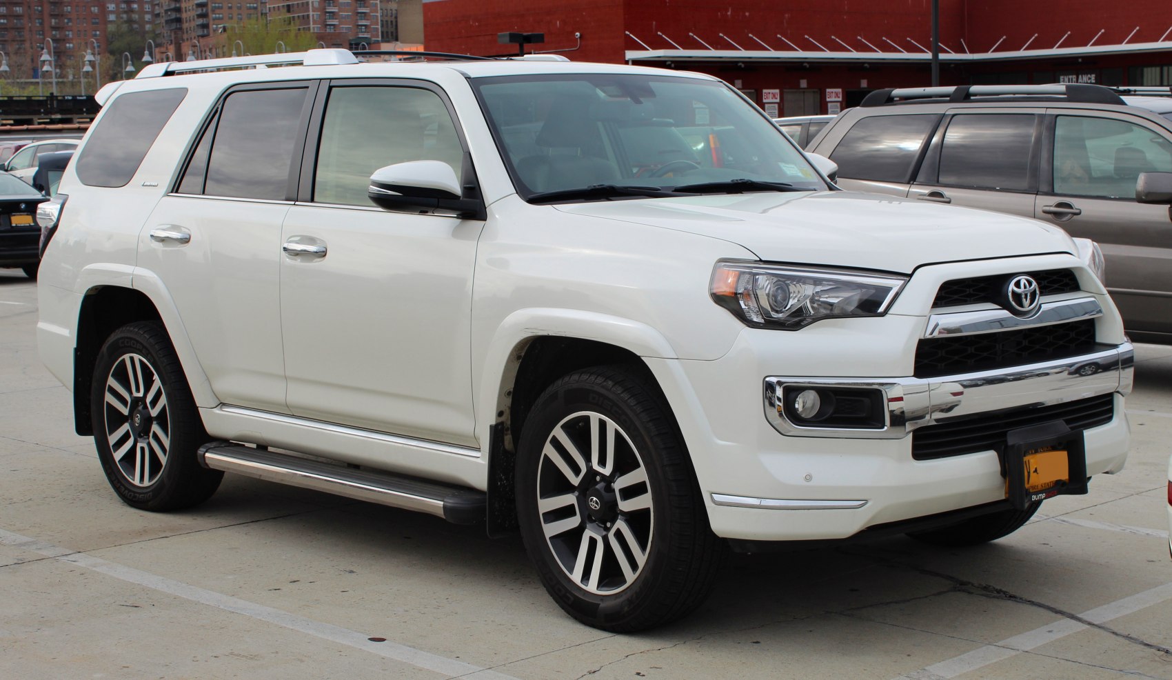 White SUV front side view with redesigned grille and alloy wheels