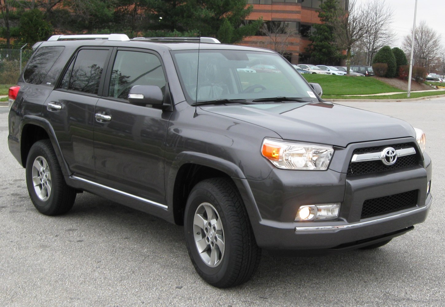 Rugged SUV front side view with alloy wheels and roof rails