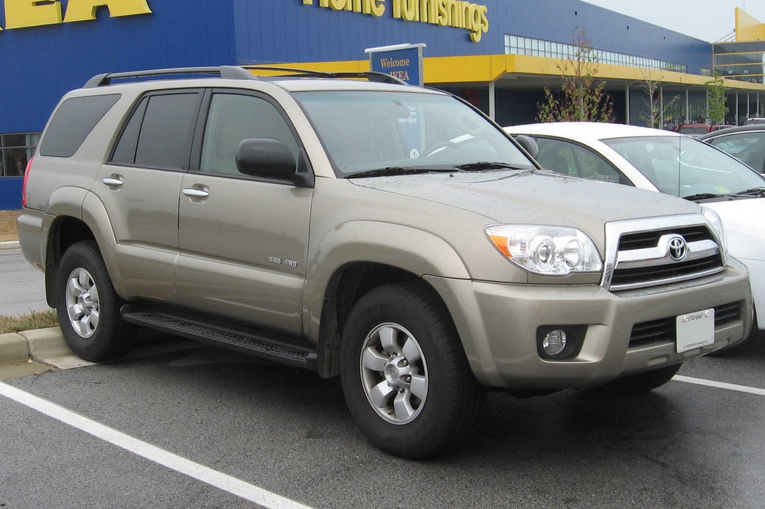 Front-side view of beige SUV with alloy wheels and rugged design