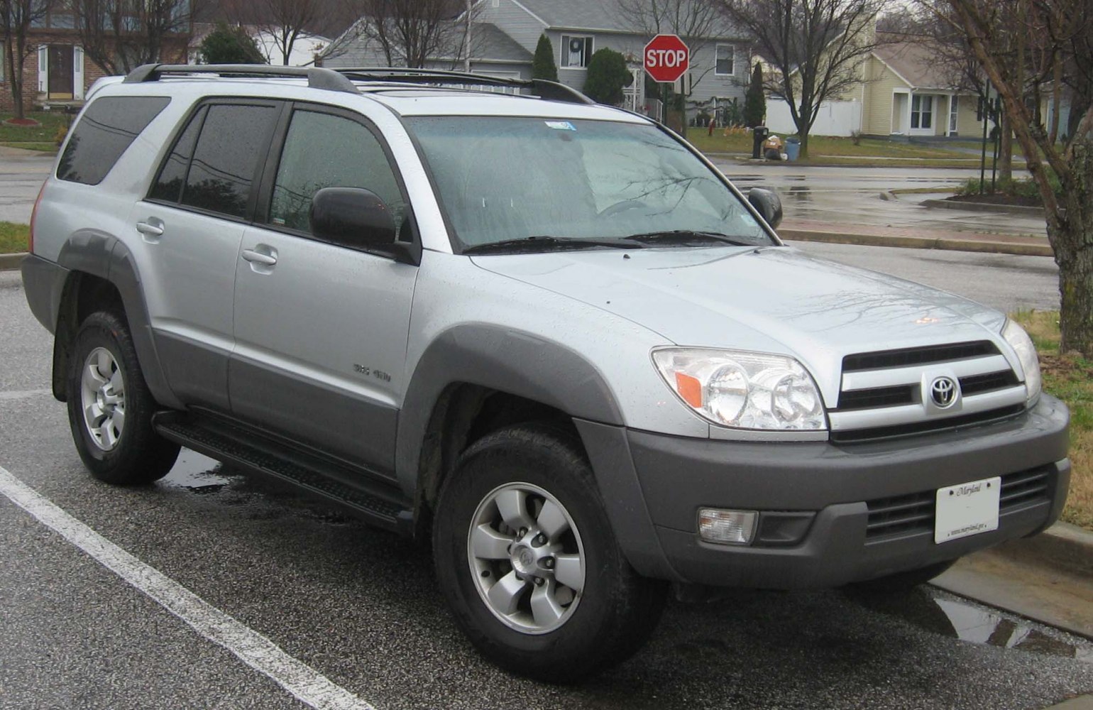 Silver SUV with two-tone cladding, roof rails, and alloy wheels parked outdoors