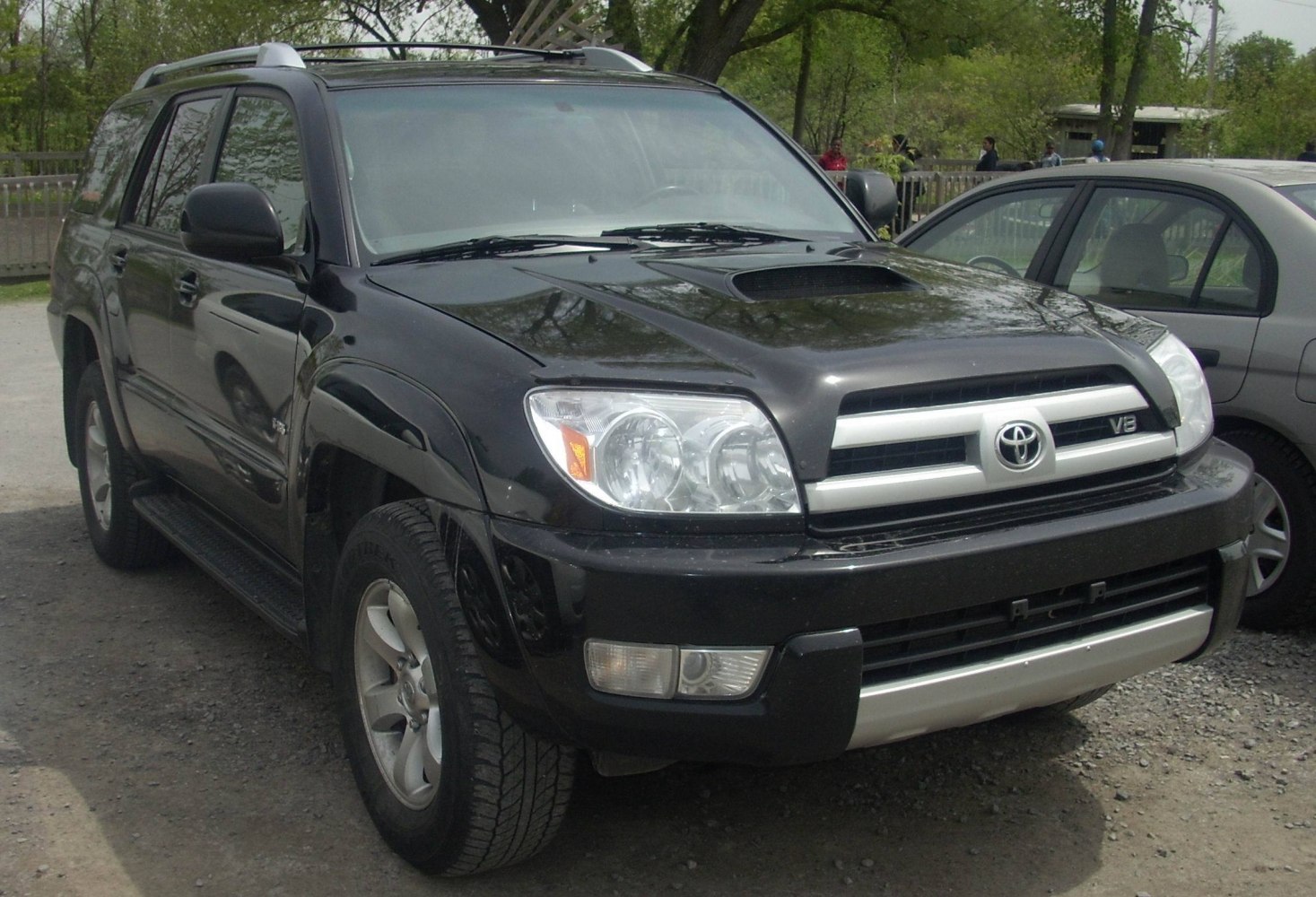 Front view of SUV with hood scoop and V8 emblem