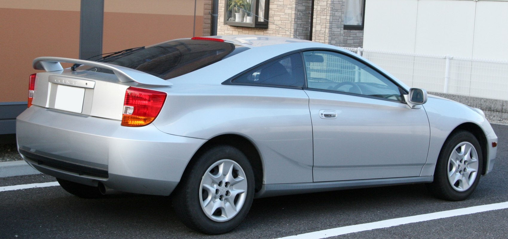 Silver coupe with distinct rear spoiler and smooth side profile