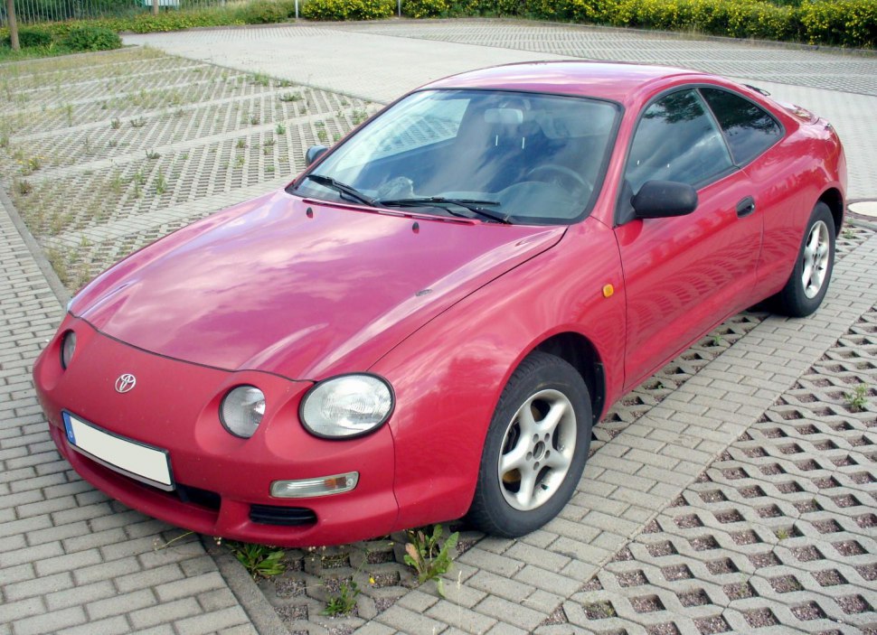 Red sports coupe with round headlights and two-door design