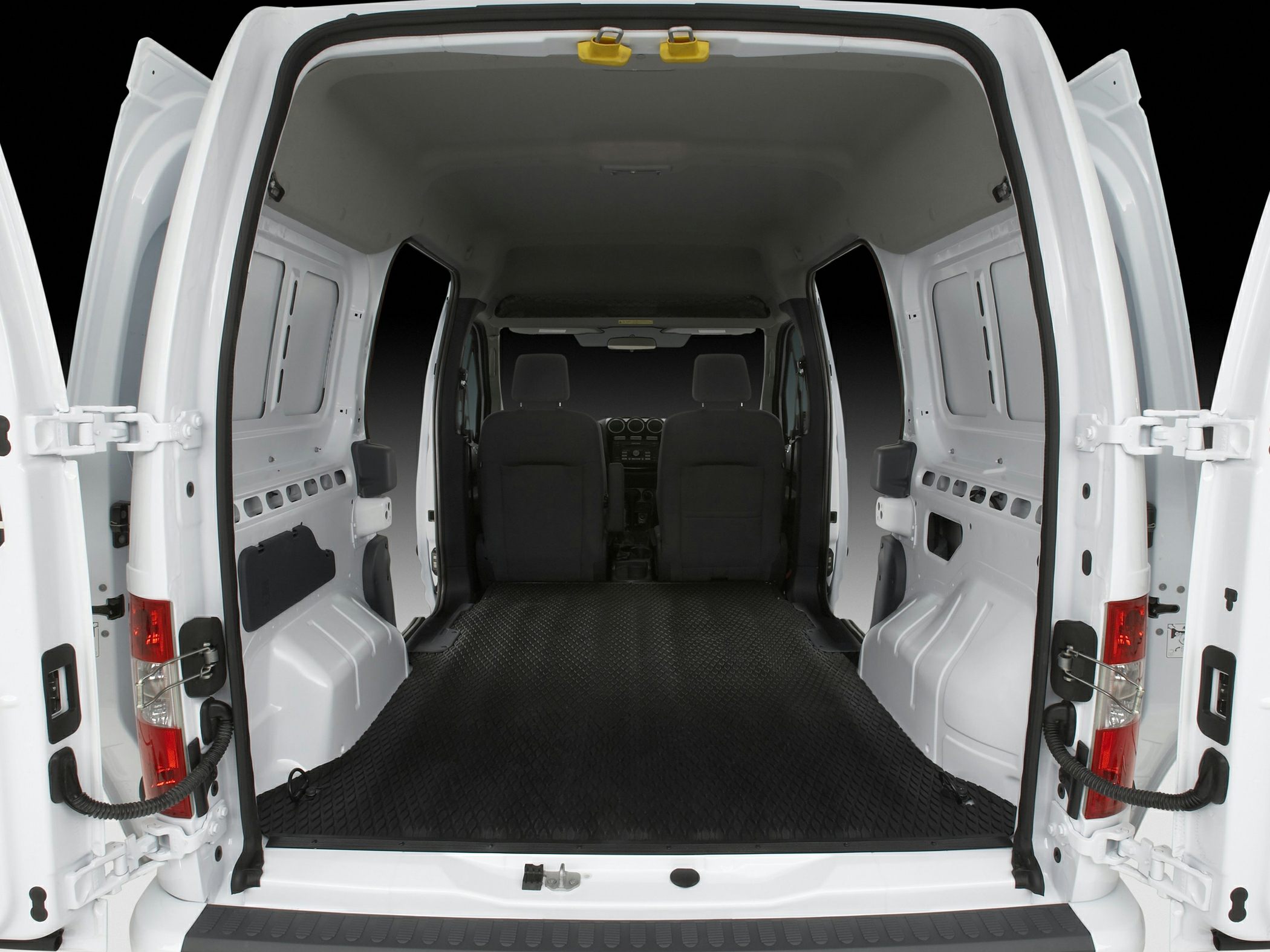 Large cargo space with open rear doors and rubber flooring