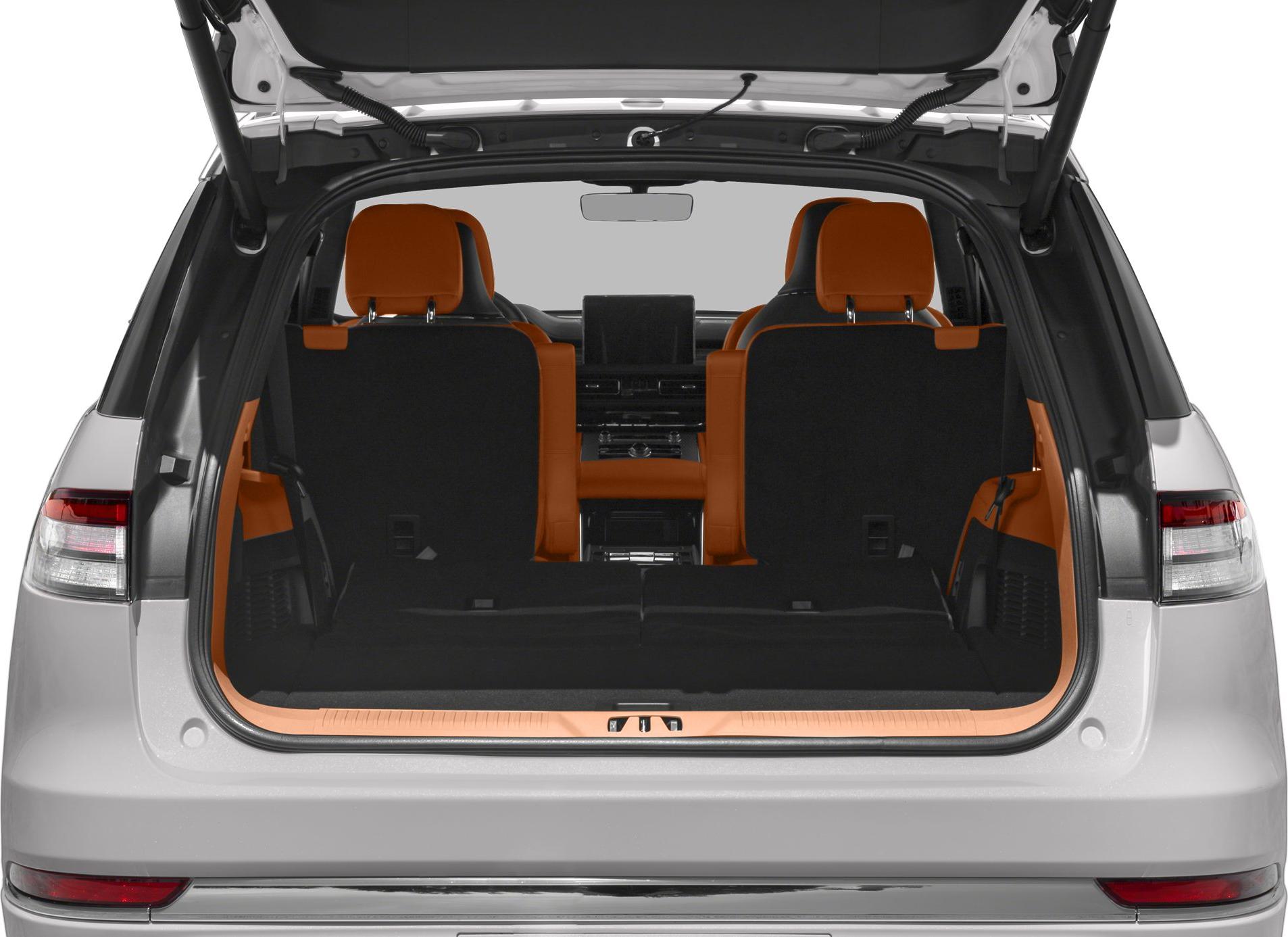 Open rear cargo area with orange-accented seats and folded rear seats.