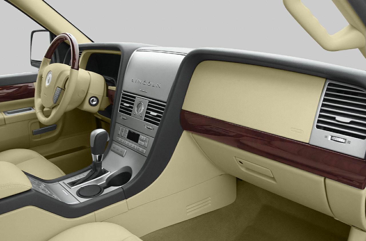 Beige car interior with wood trim and central dashboard