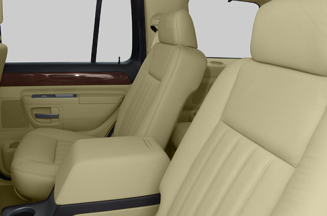 Beige leather seats and wood trim door panel in upscale SUV interior