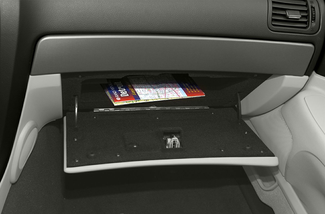 Open glove compartment with storage space inside a car interior