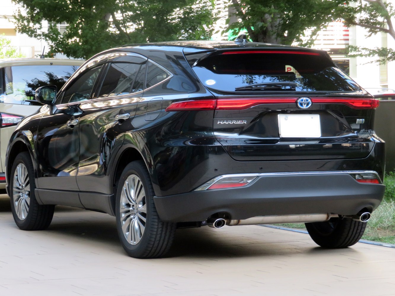Rear side view of modern black SUV with sleek taillights and dual exhaust