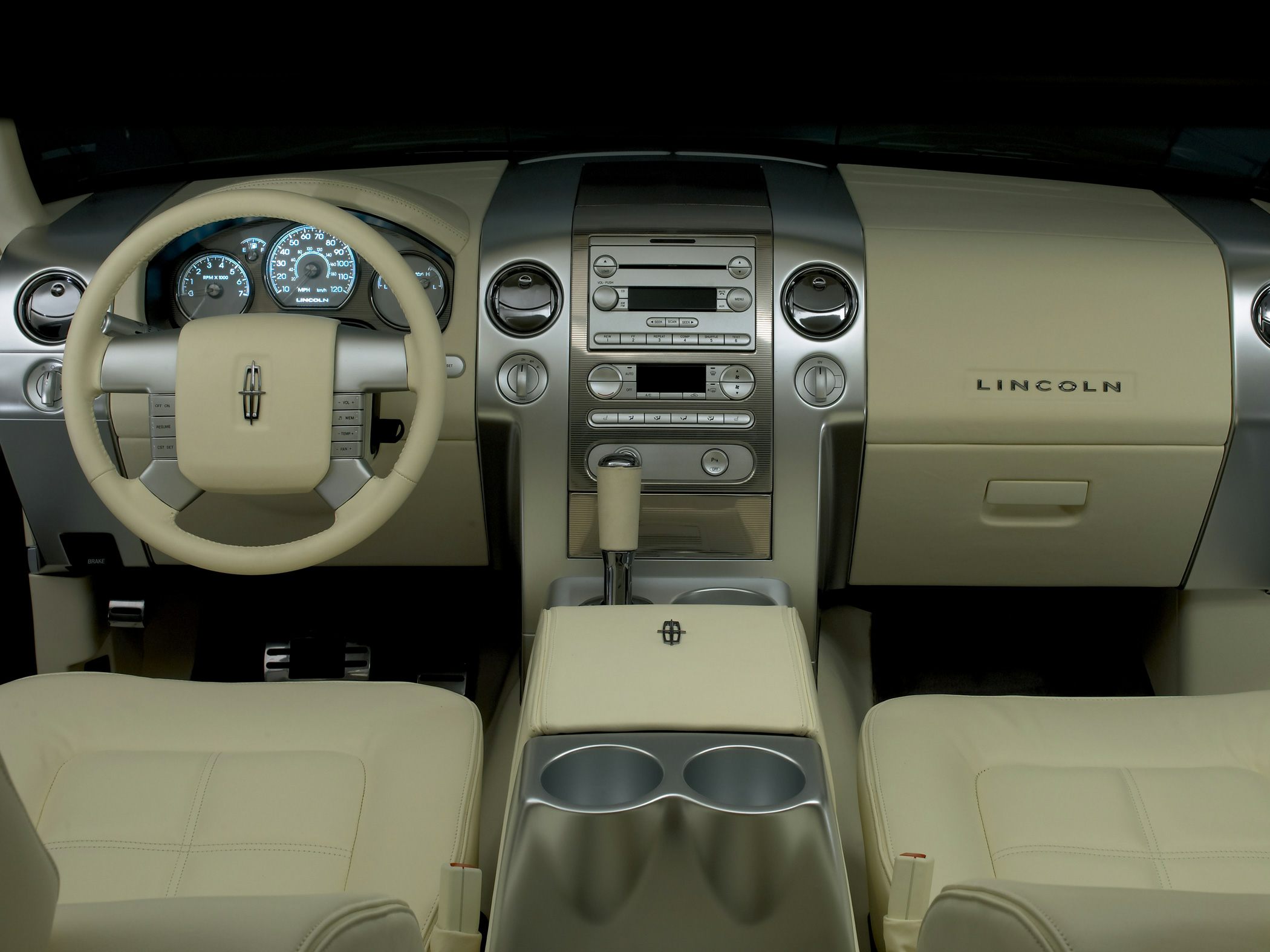 Beige luxury interior with dashboard, steering wheel, and center console