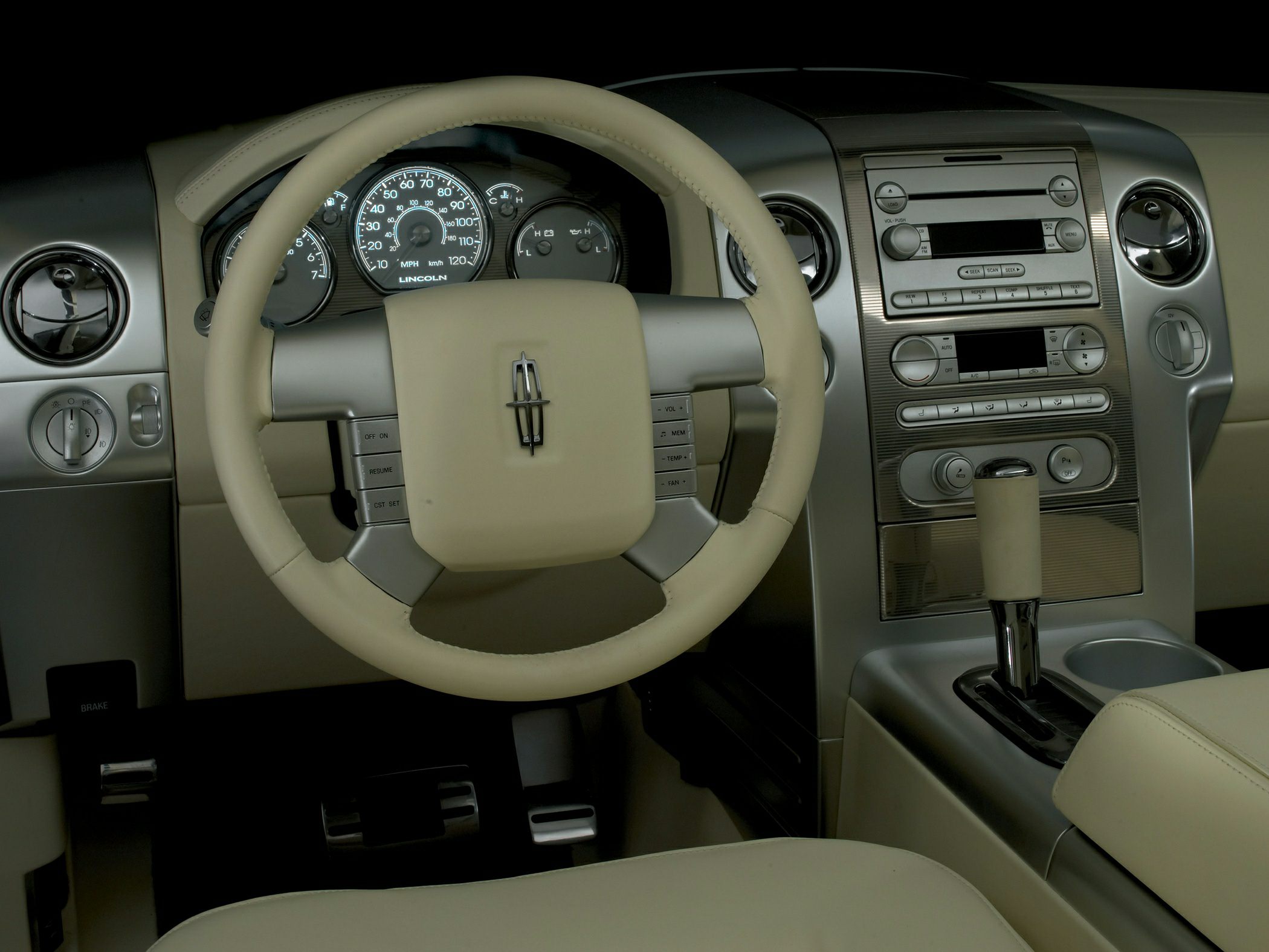 Leather-wrapped steering wheel and analog gauge dashboard