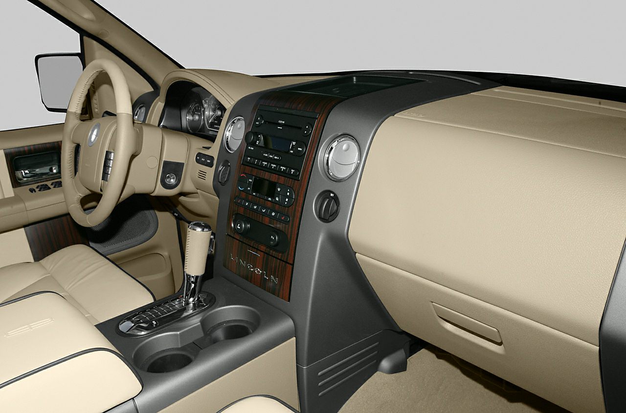 Beige luxury interior with wood trim and automatic gear shift