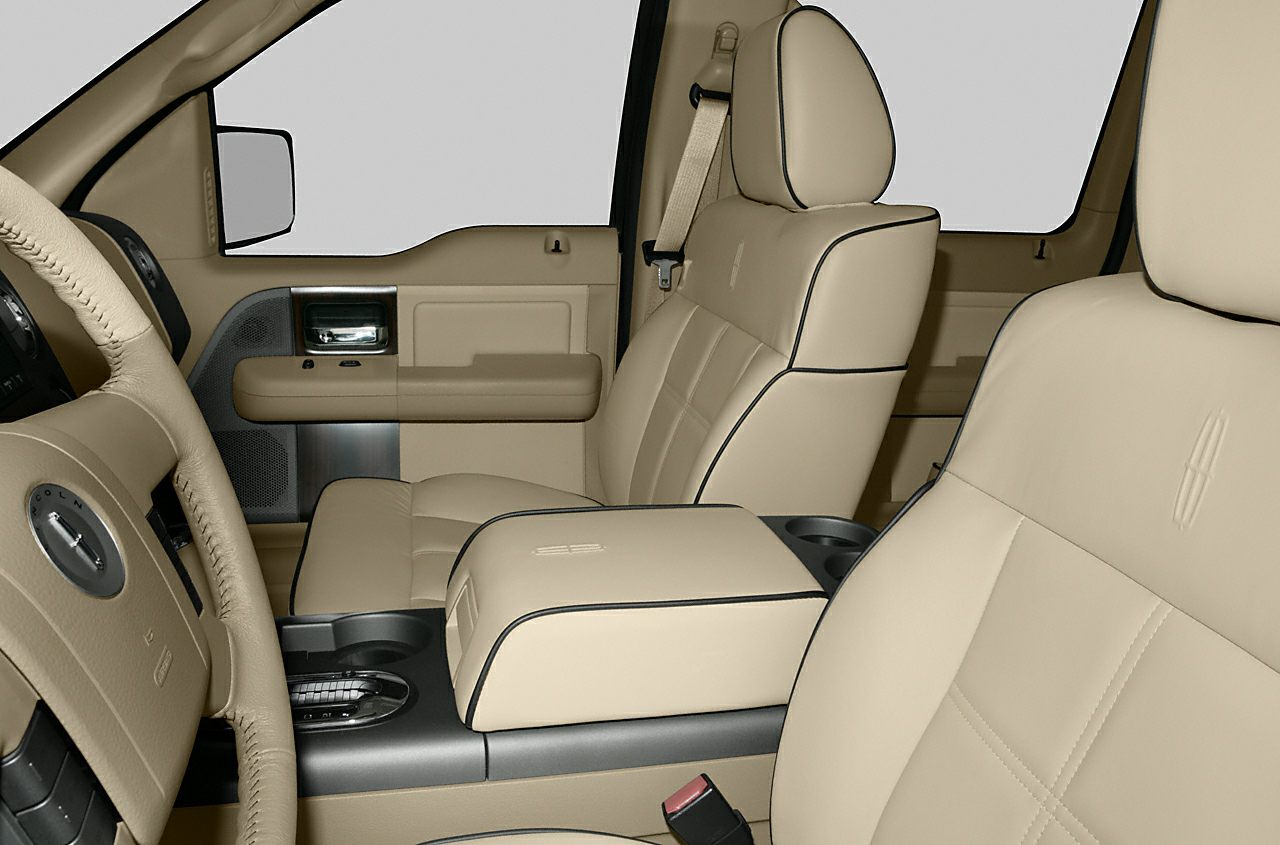 Beige leather seats with black piping and embossed logo